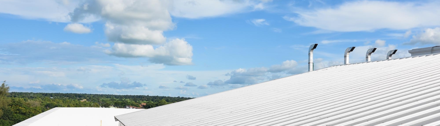 Side view of a white industrial roof on a sunny day