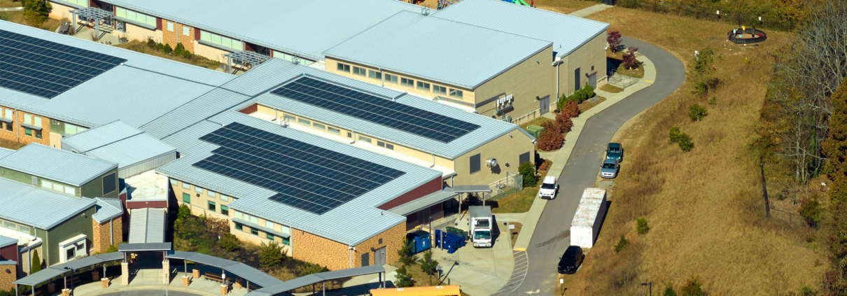 Roof of american school building covered with photovoltaic solar panels