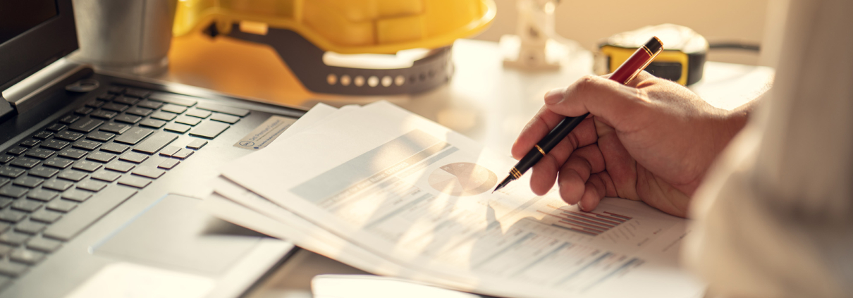 Side view of construction worker making notes