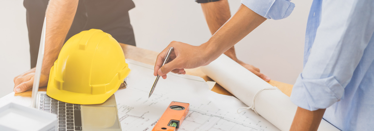 Construction of engineer, architect young businessman, colleague male hand in use pen point to blueprint paper in office