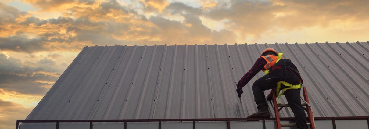 Worker inspecting commercial roof