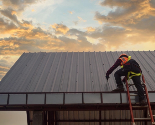 Worker inspecting commercial roof