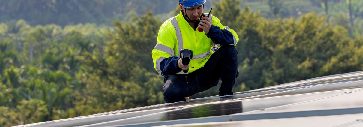 roofer using infrared camera to find leaks on roof