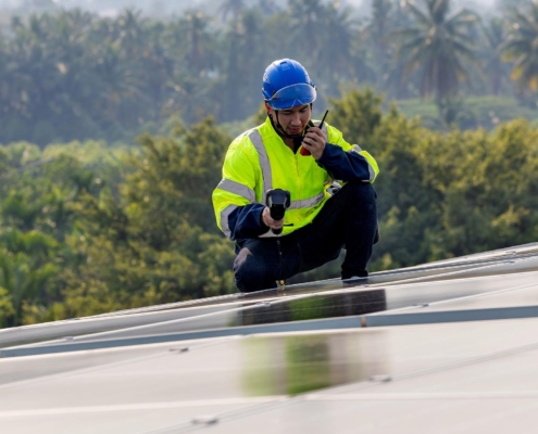 roofer using infrared camera to find leaks on roof