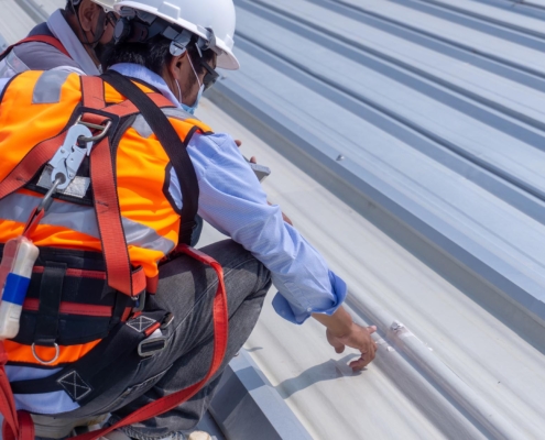 Workers inspecting roof leak